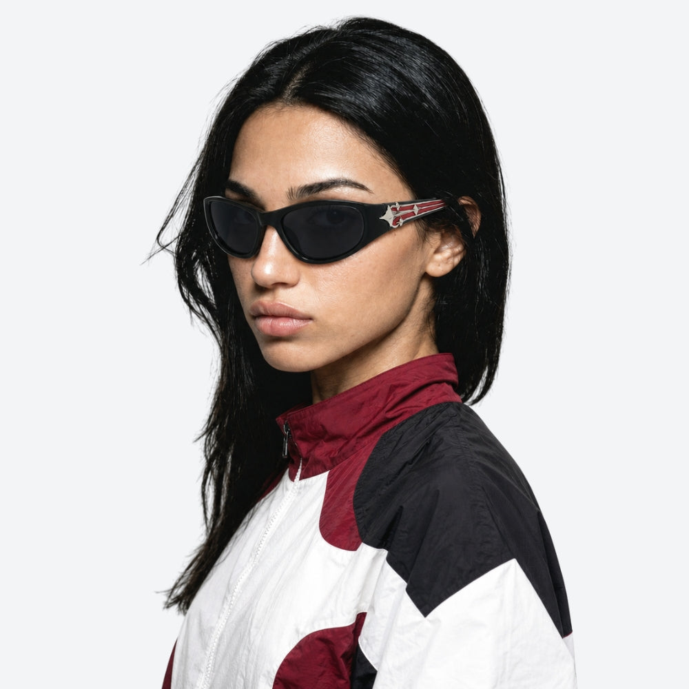Person wearing VYSER Black sunglasses with red and white design on a white background