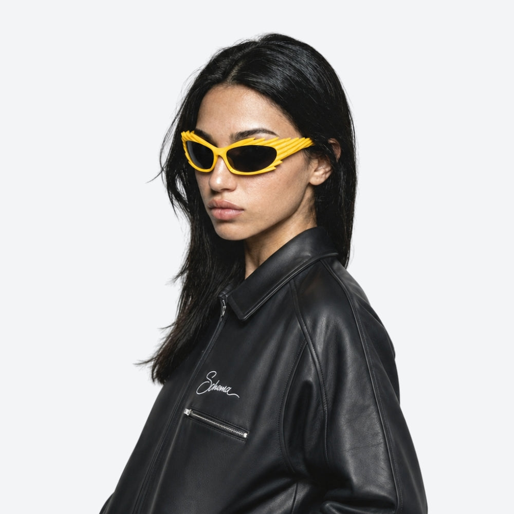 Person wearing yellow VYSER Yellow sunglasses with a unique frame design on a white background