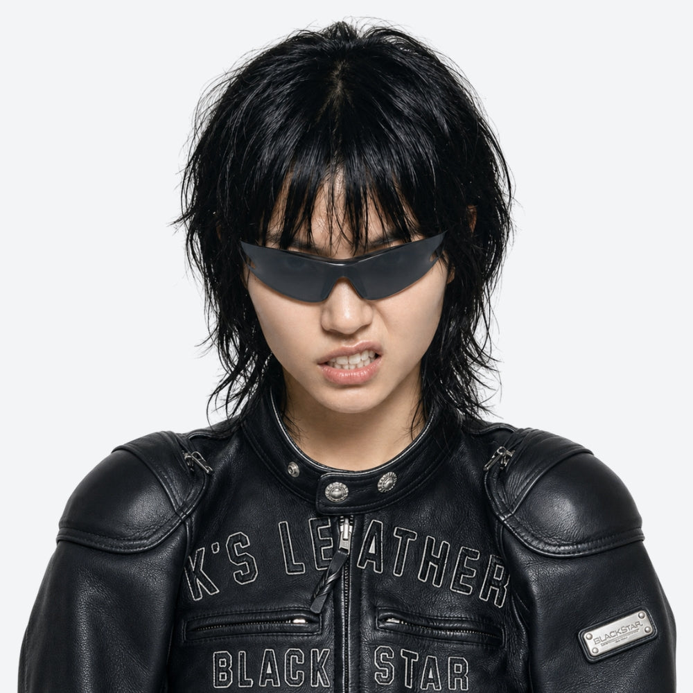 Person wearing a VYSER Sunglasses with black frame and dark lenses on a white background