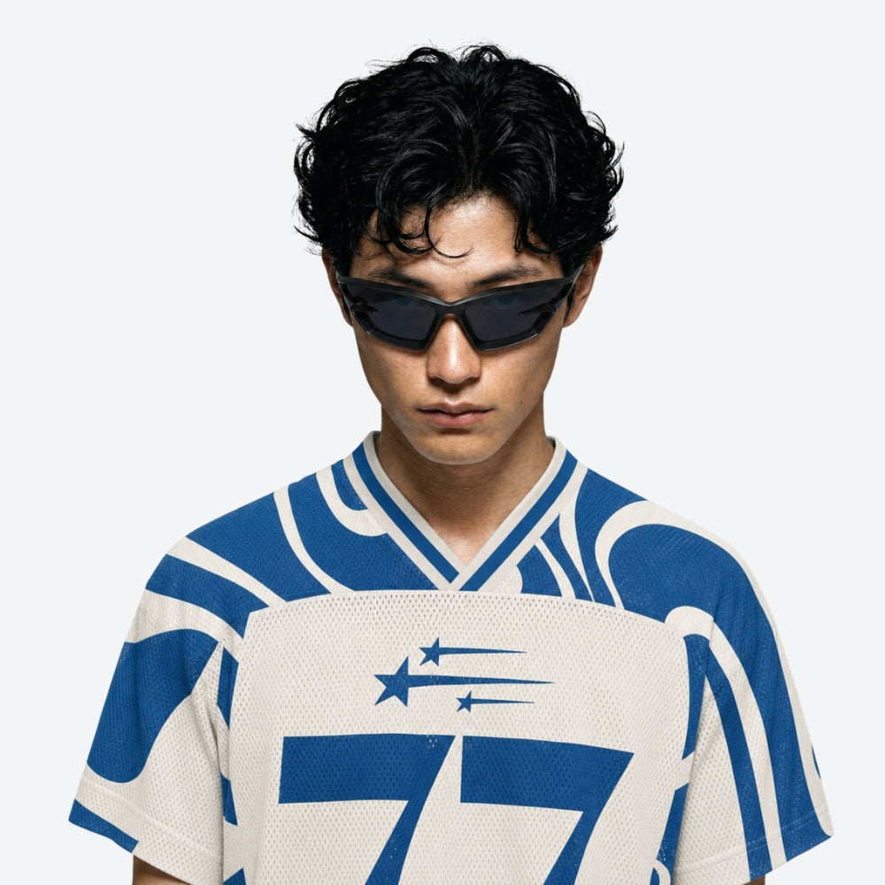 Person wearing a blue and white sports jersey with VYSER Black sunglasses with a white background