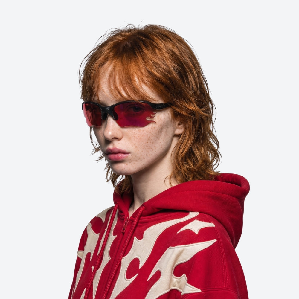 Person using VYSER Black sunglasses with redlenses on a white background