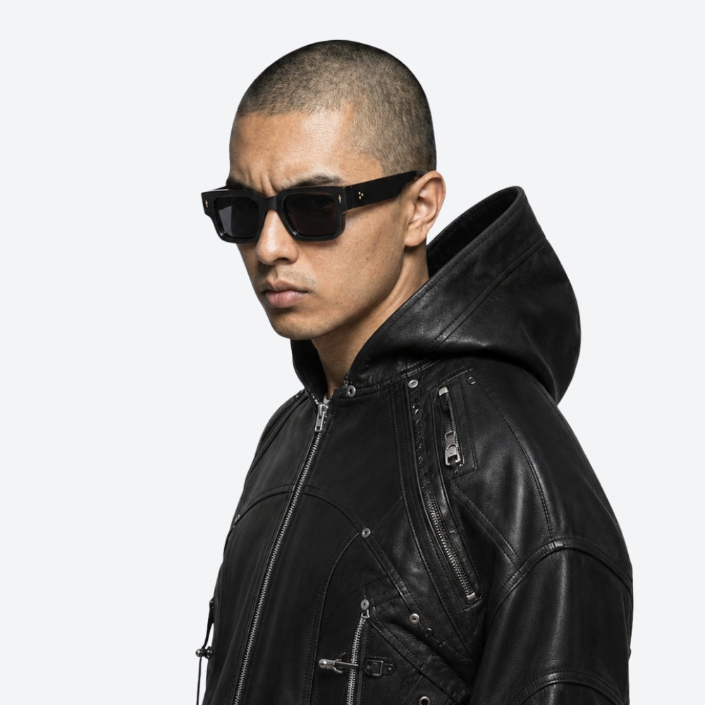Person wearing a black leather jacket and VYSER Black sunglasses with dark lenses on a white background