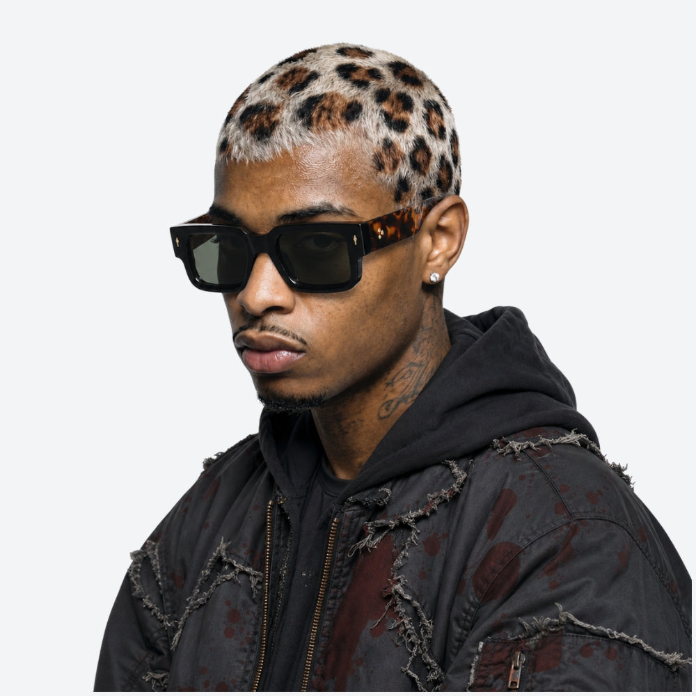 Person wearing VYSER Sunglasses with tortoiseshell arms on a white background