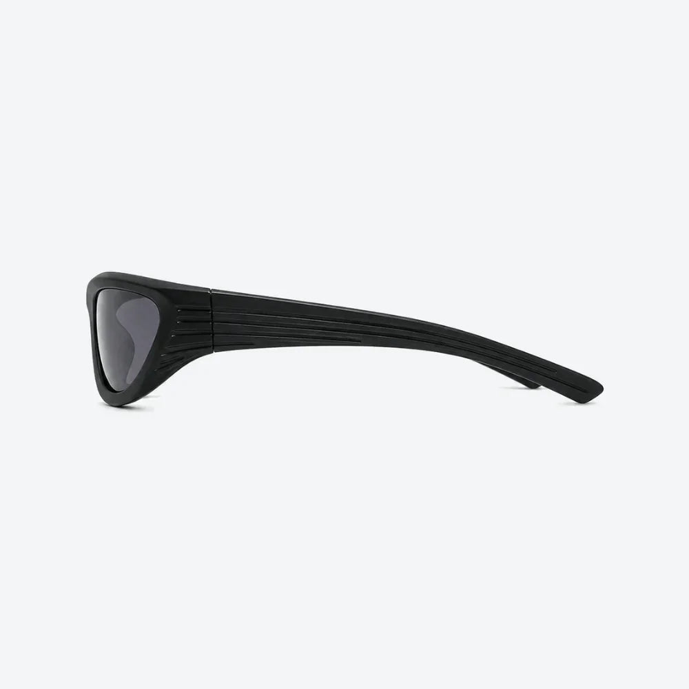 VYSER Black wrap-around shield sunglasses with dark gray lenses, shown from a three-quarters angle on a light gray background.