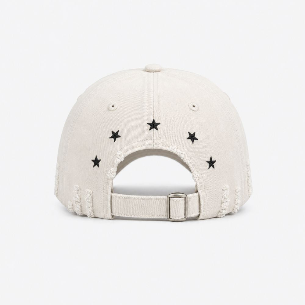 Back view of a cream distressed baseball cap with small embroidered stars and an adjustable buckle strap