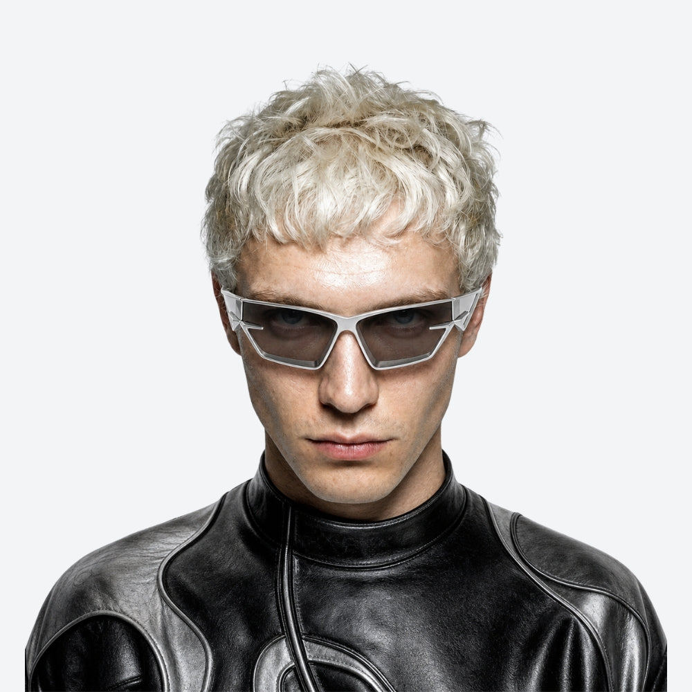Person wearing futuristic VYSER Silver sunglasses with a clear frame on a white background