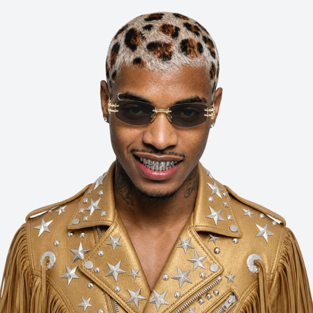 Man wearing a gold jacket with star patterns and VYSER Sunglasses with decorative gold frame on a white background
