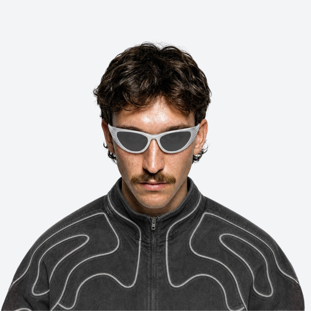Person wearing futuristic VYSER White wrap-around sunglasses with a sleek, futuristic design and silver mirrored lenses, shown on a white background.
