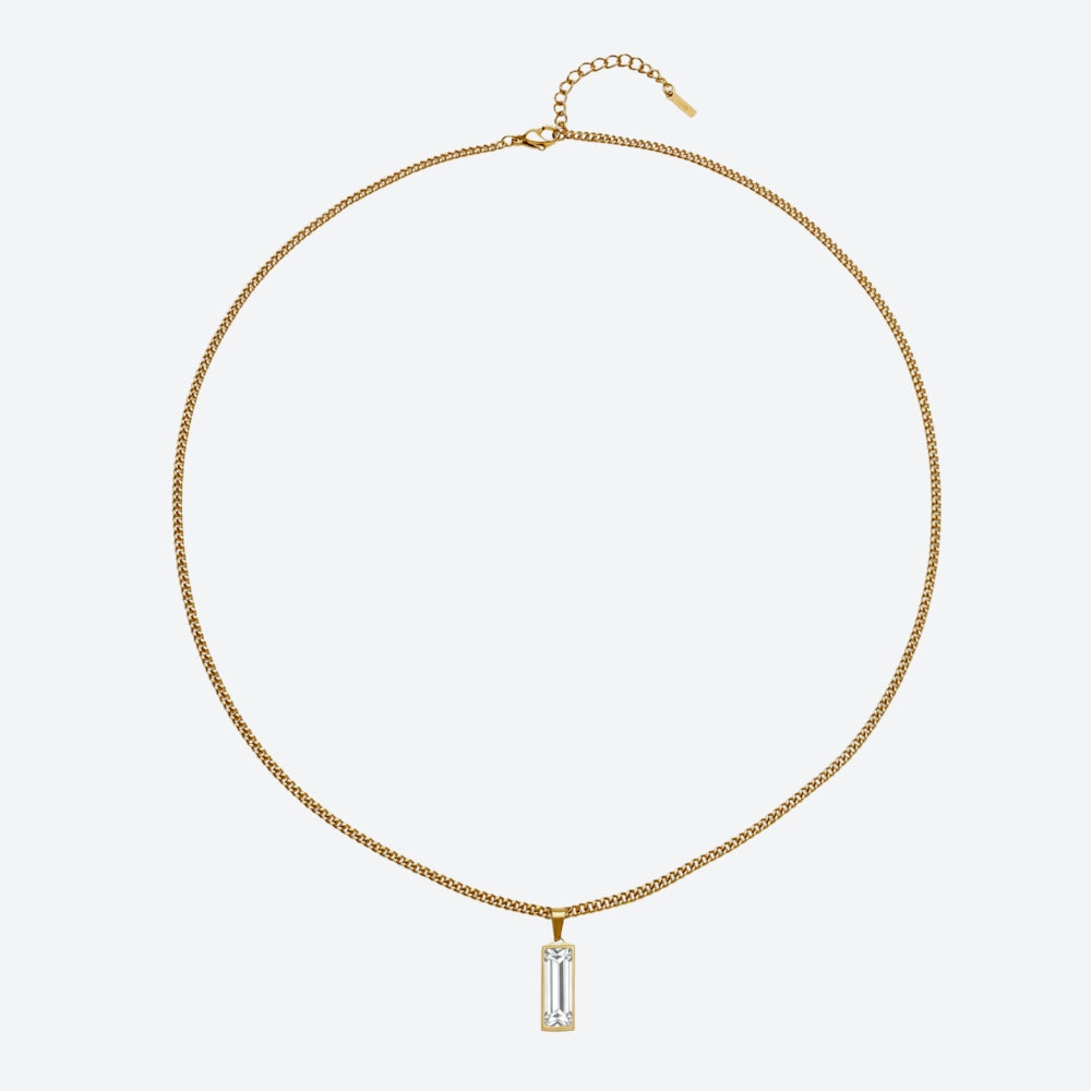 A gold chain necklace with a rectangular baguette-cut clear gemstone pendant, displayed on a clean light gray background.