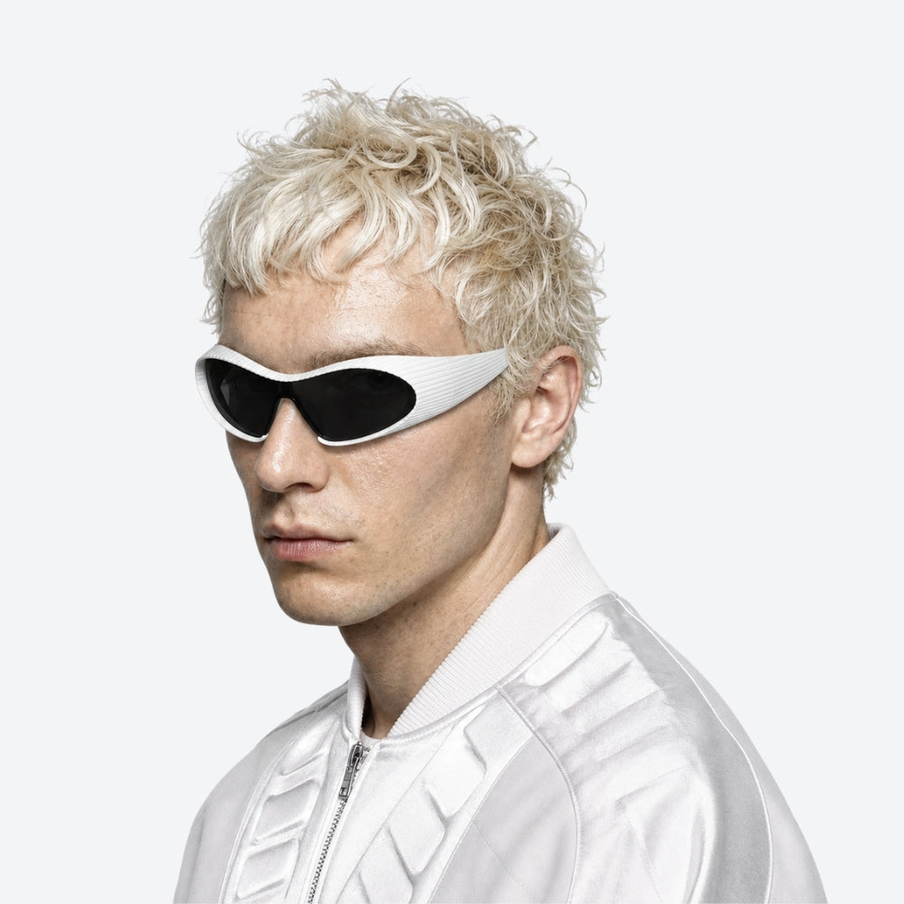 Person with blonde hair wearing VYSER white Sunglasses with hexagonal lenses on a white background