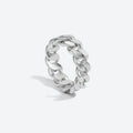 A polished silver-tone chunky curb link ring standing upright on a light gray background with a soft shadow.