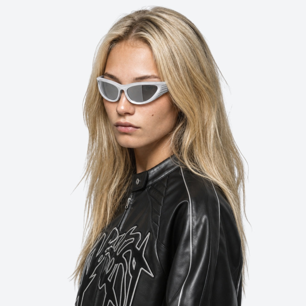 Person wearing a black leather jacket and VYSER White wrap-around sunglasses with a sleek, futuristic design and silver mirrored lenses, shown on a white background.