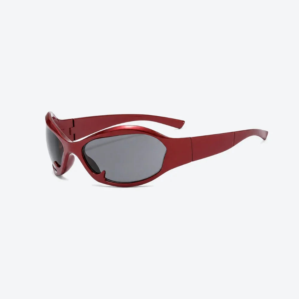 VYSER red wraparound sunglasses with sleek matte frame and dark gray lenses, modern streetwear style.