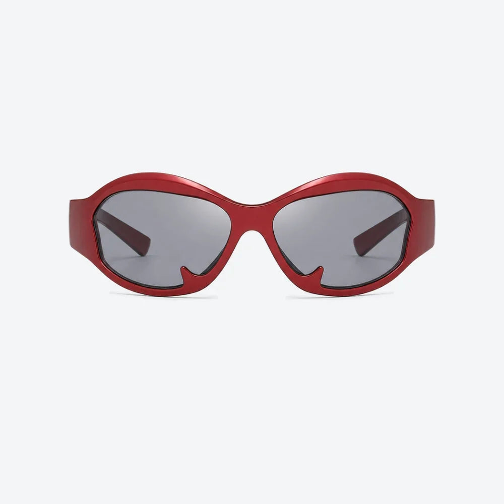 VYSER bold red acetate sunglasses with angular cat-eye frame and gray mirrored lenses, modern streetwear style.