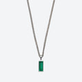 A silver-toned chain necklace with a rectangular green gemstone pendant, shown against a light gray background.