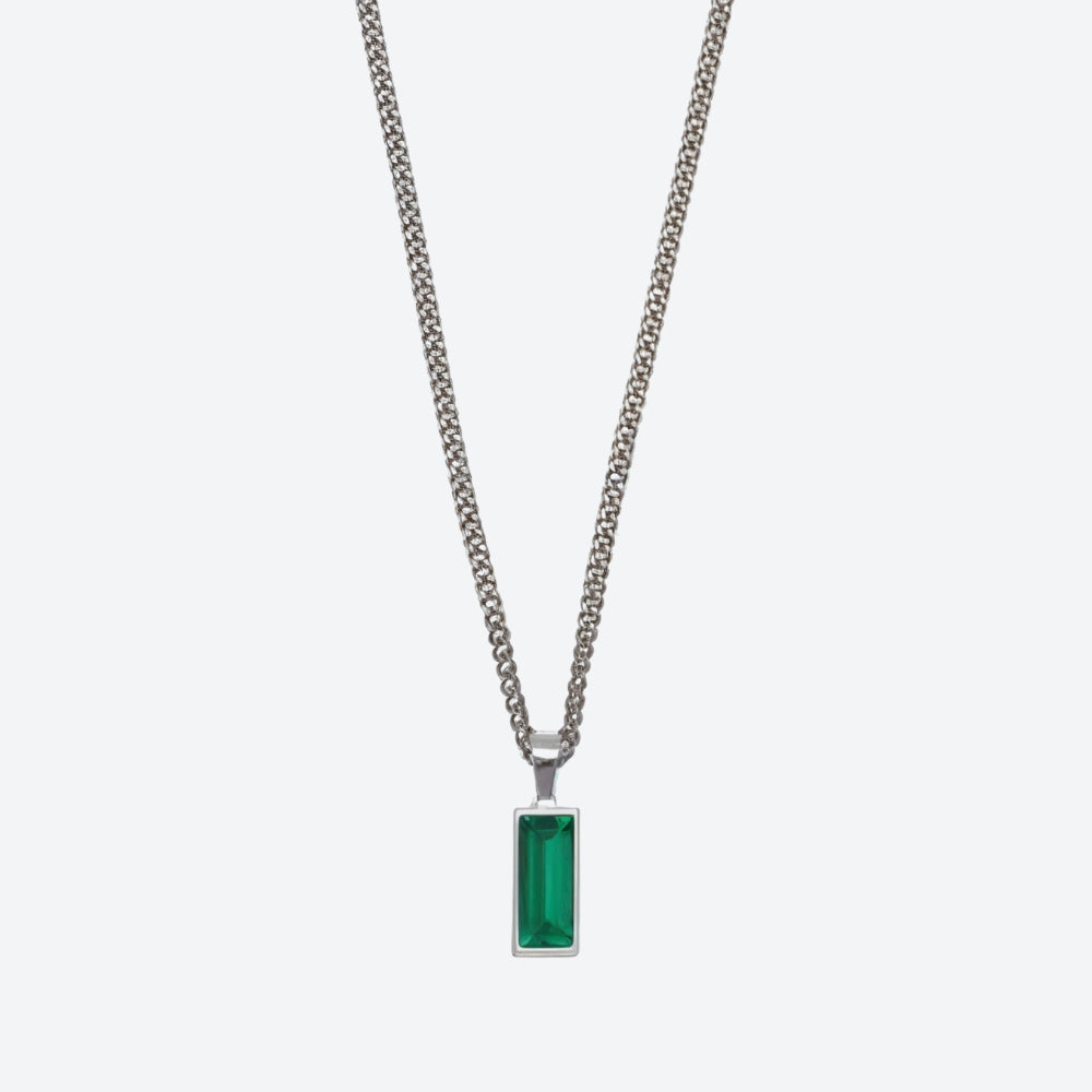 A silver-toned chain necklace with a rectangular green gemstone pendant, shown against a light gray background.