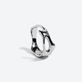 A polished silver-toned ring with an organic, wavy openwork design, photographed on a clean light gray background with a soft shadow.