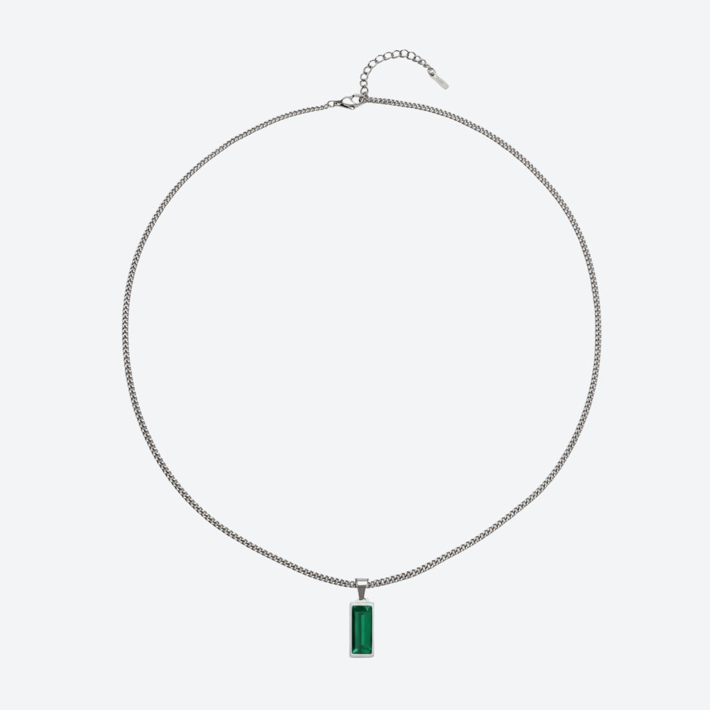 A silver-toned chain necklace with a rectangular green gemstone pendant, displayed against a light gray background.