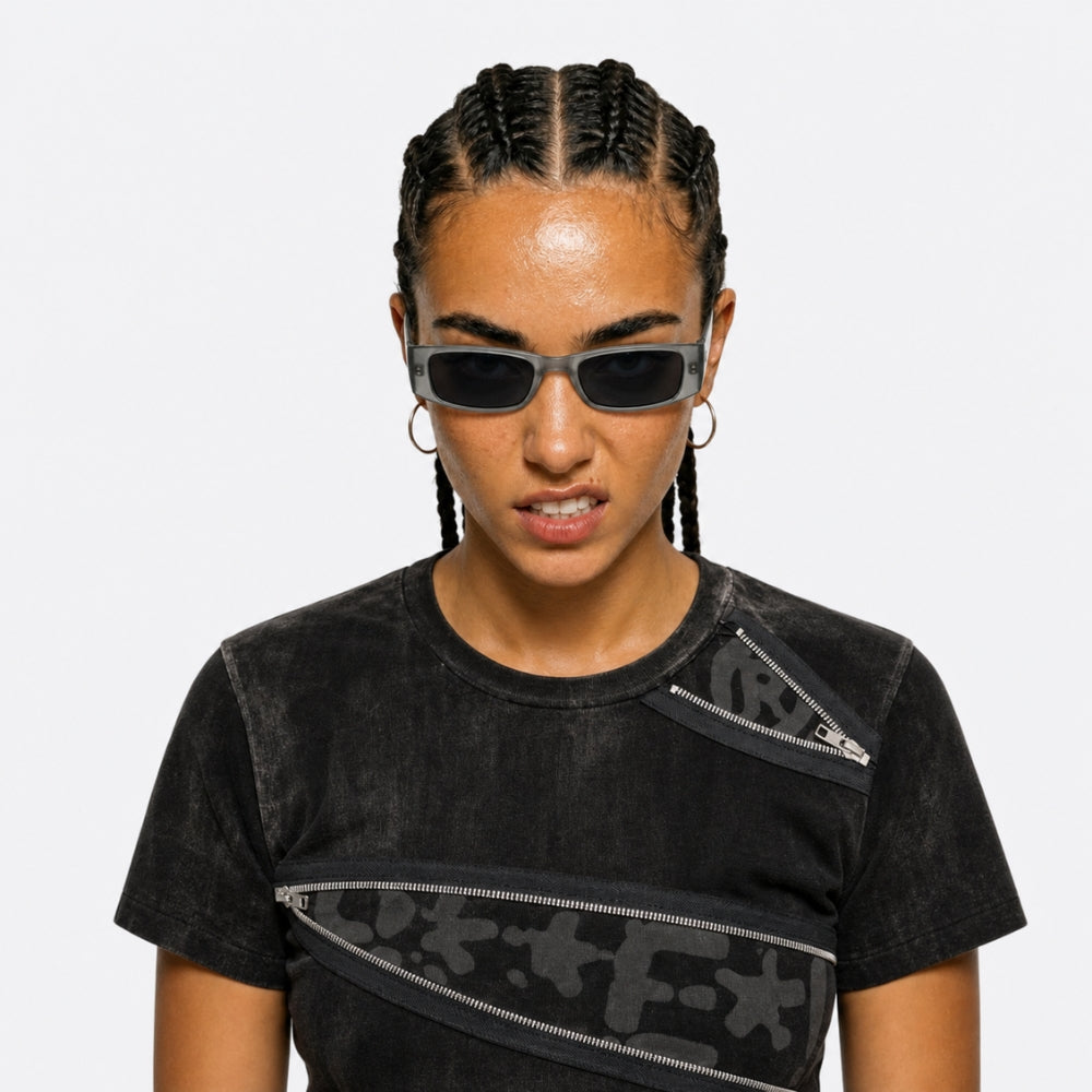 Person wearing a VYSER silver transaprent frame sunglasses on a white background