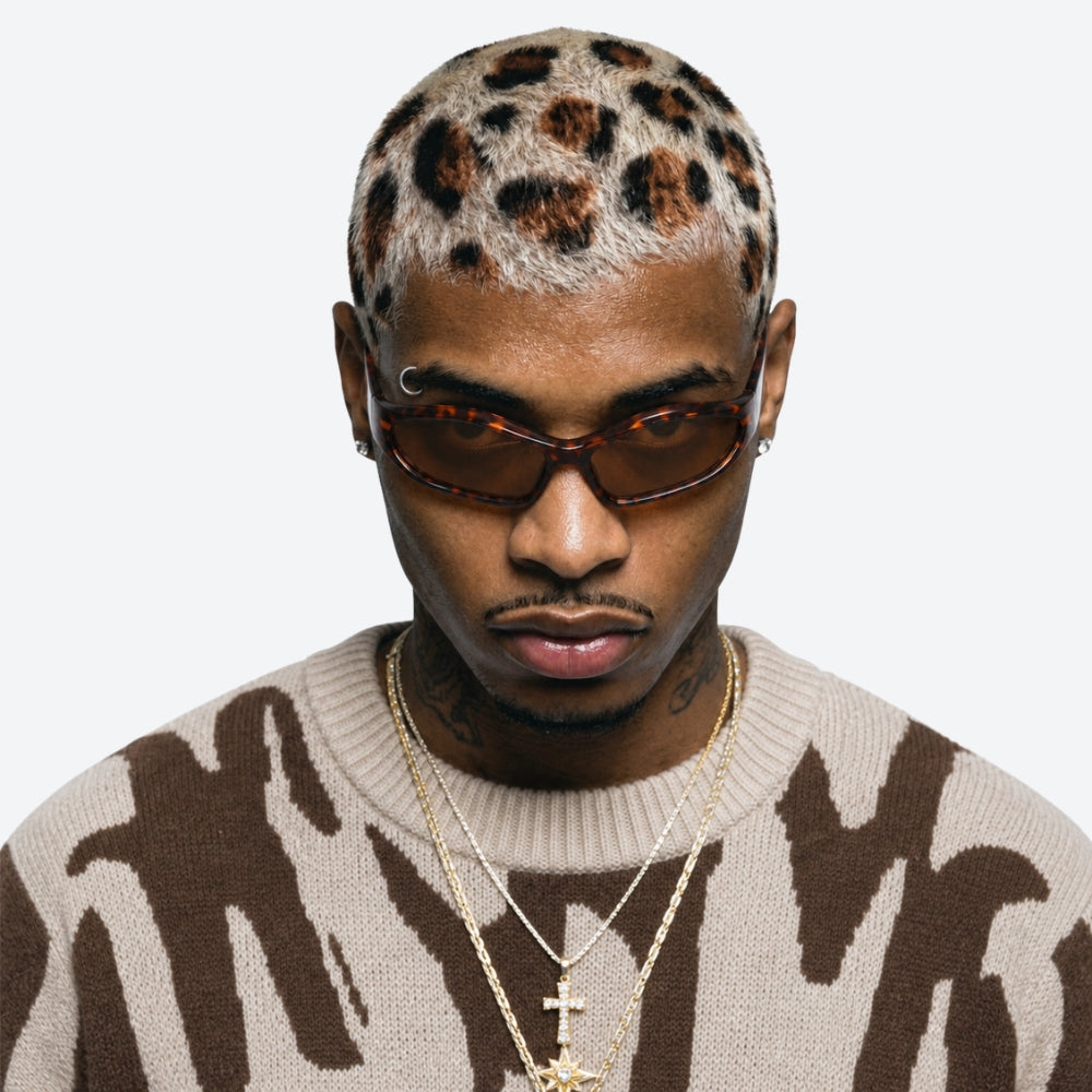 Man wearing a sweater with VYSER Sunglasses with tortoiseshell frame and brown lenses on a white background
