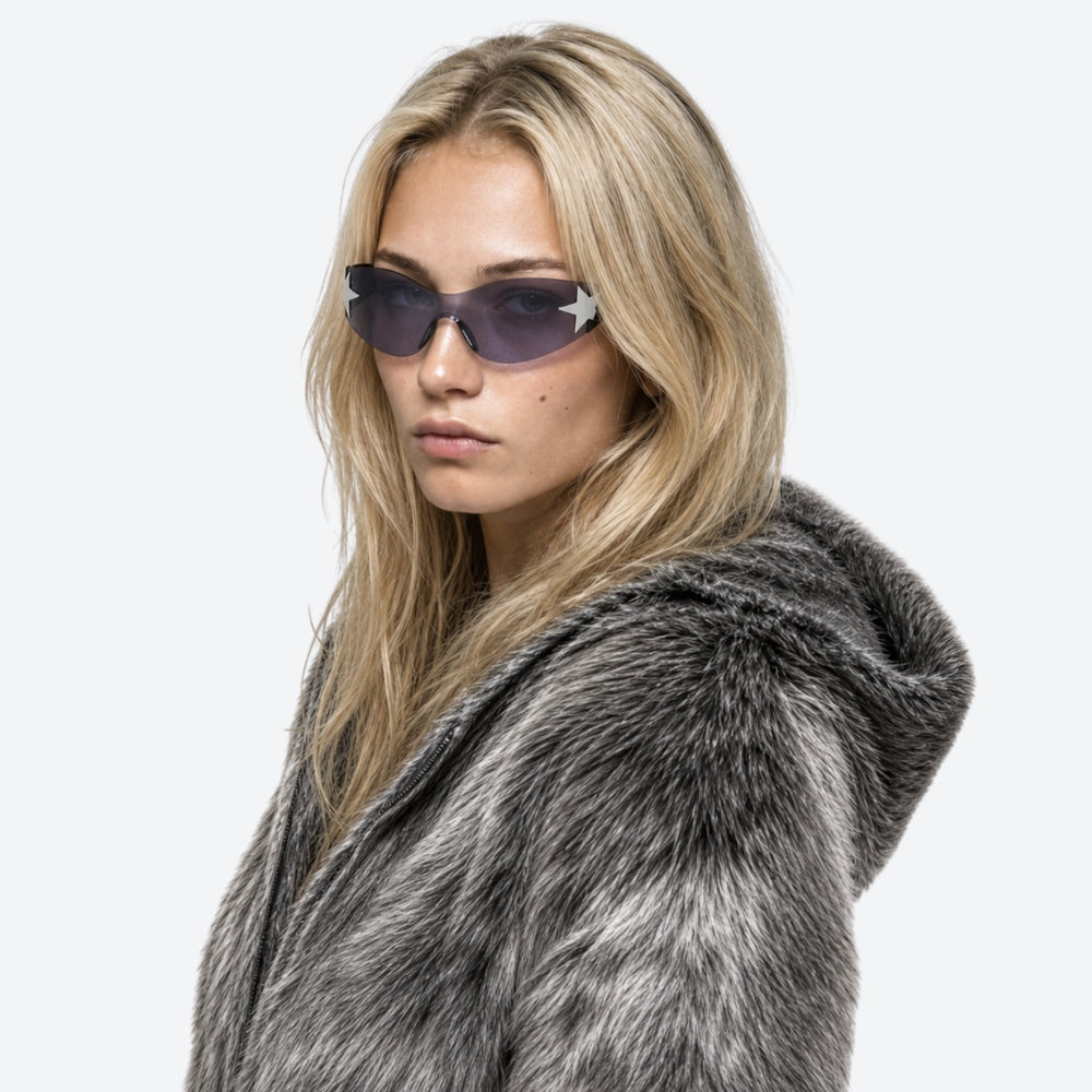 Woman wearing a fur coat and VYSER Sunglasses with a star design on a white background