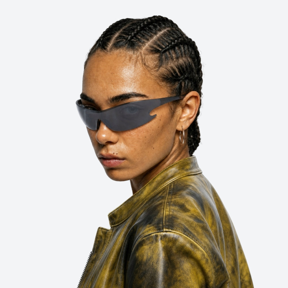 Person wearing VYSER Sunglasses with black frame and dark lenses on a white background