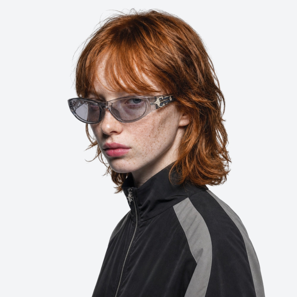 Person with red hair and VYSER Sunglasses with clear lenses and decorative frame on a white background