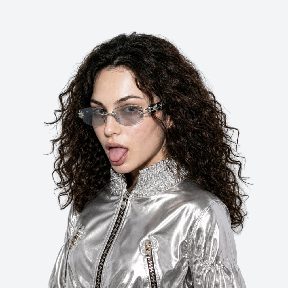 Person wearing a silver jacket and futuristic VYSER Blue car door handle on a white background
