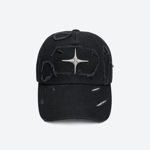 A black distressed baseball cap with a silver metallic starburst patch on the front, set against a plain light gray background.
