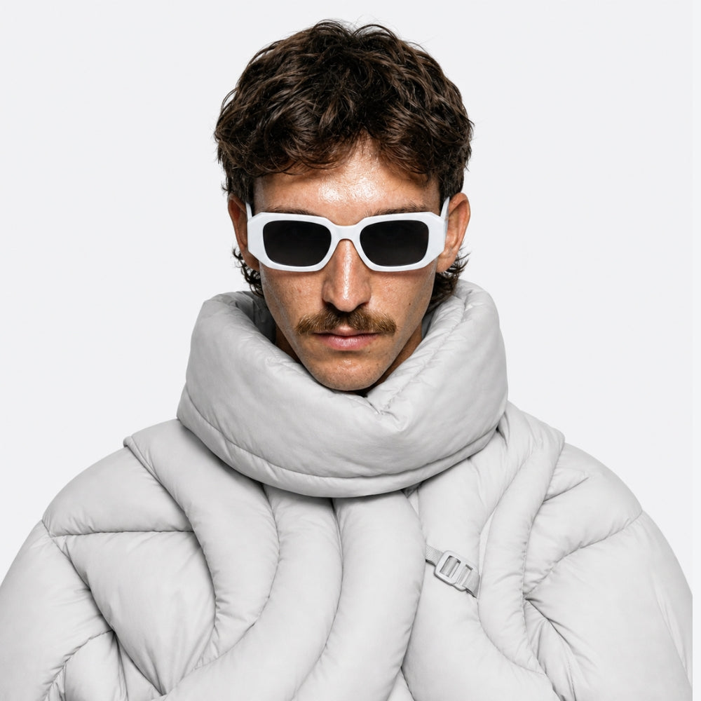 Man wearing a light gray puffer jacket and scarf with VYSER Sunglasses with white frame and black lenses on a white background
