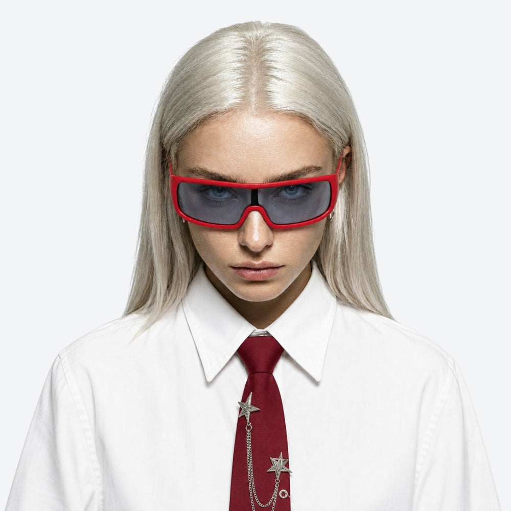 Person wearing a white shirt, red tie, and VYSER Red sunglasses with gray lenses on a white background