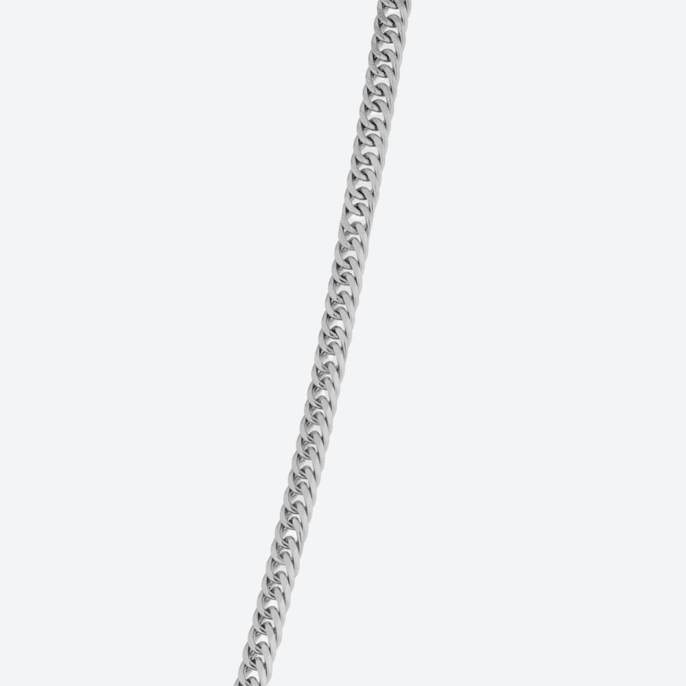 A silver-toned curb chain necklace shown against a plain light gray background.