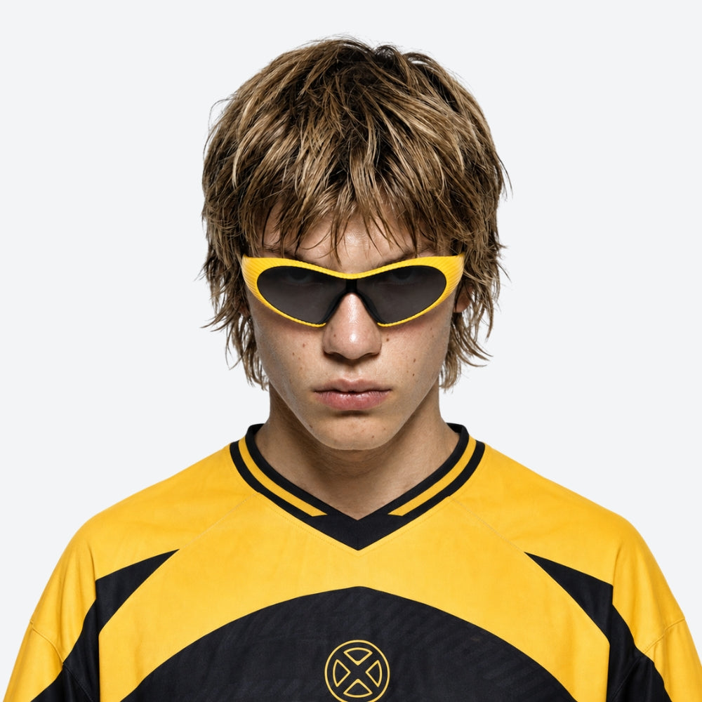 Person wearing a yellow and black sports jersey with VYSER Yellow sunglasses with black lenses on a light gray background