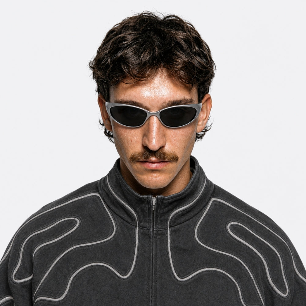 Man wearing VYSER Silver sunglasses with dark lenses on a white background