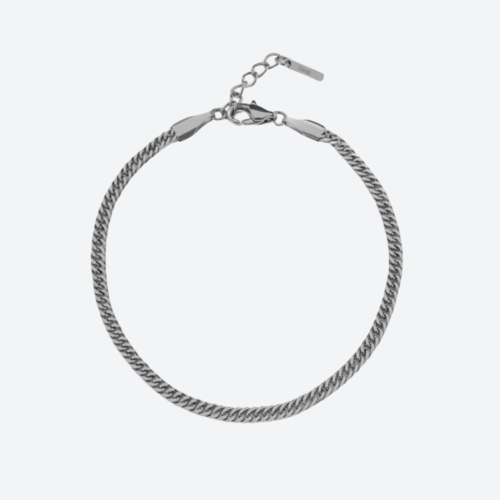 SILVER. A silver-toned Cuban curb chain bracelet with a lobster clasp and extension chain, on a light gray background.