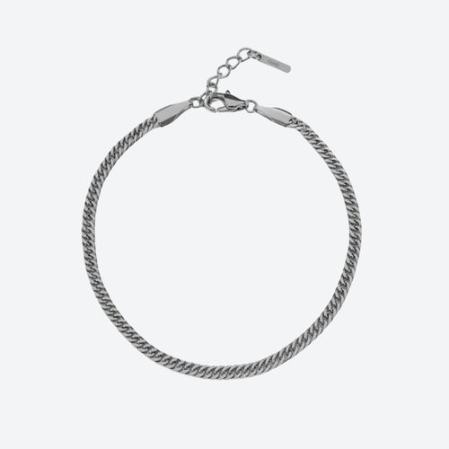 SILVER. A silver-toned Cuban curb chain bracelet with a lobster clasp and extension chain, on a light gray background.