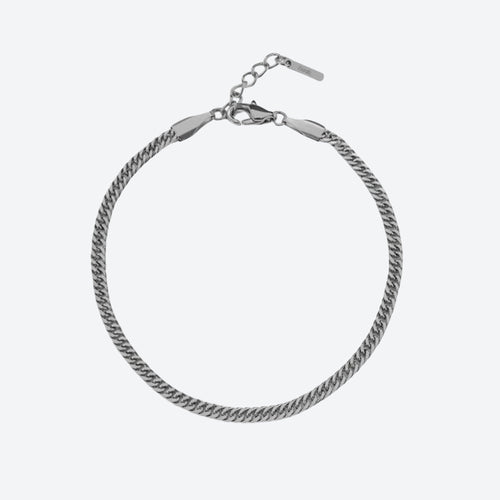 SILVER. A silver-toned Cuban curb chain bracelet with a lobster clasp and extension chain, on a light gray background.