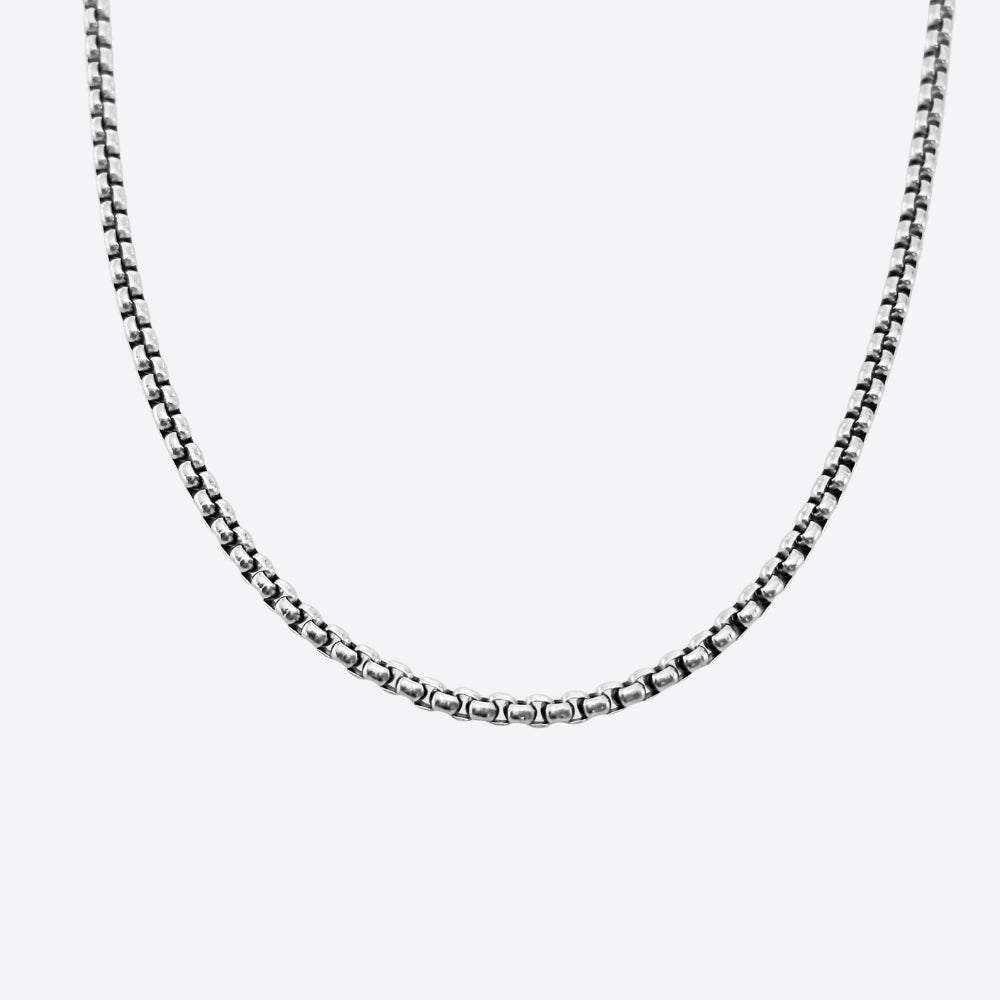 SILVER. A silver-toned box chain necklace shown against a plain light gray background.