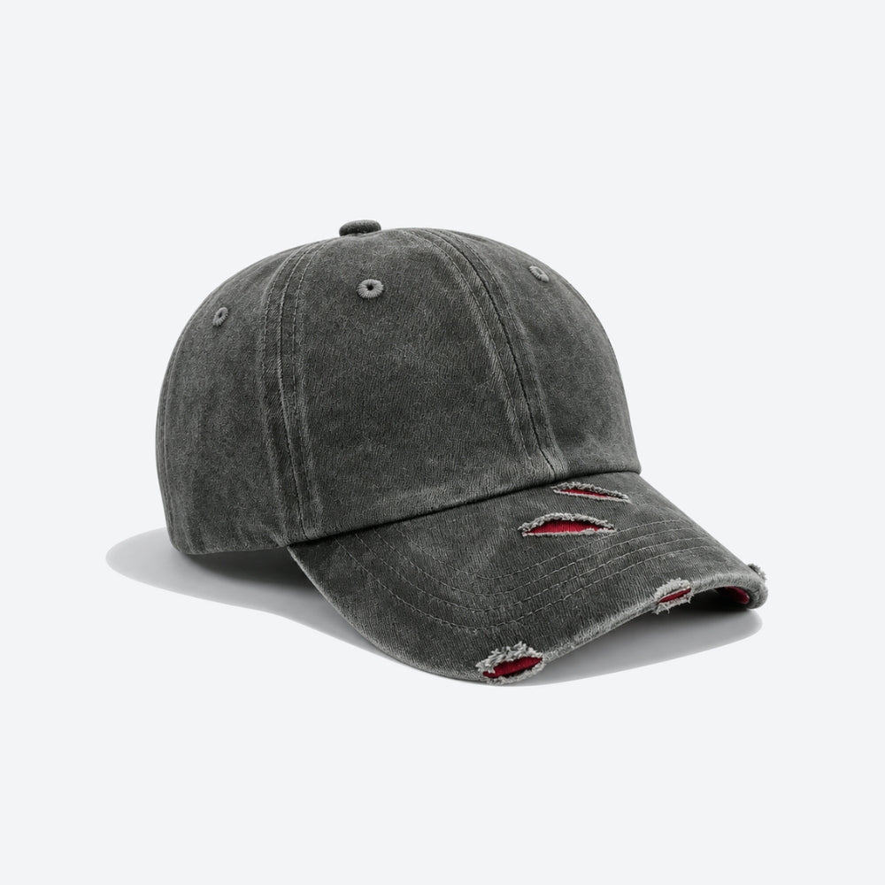A dark grey washed baseball cap with red slash embroidery across the brim, shown from a three-quarter angle