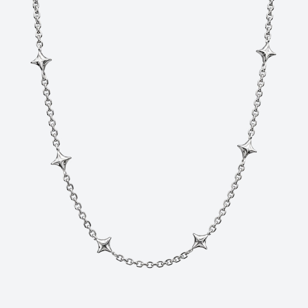 A silver chain necklace featuring five evenly spaced, polished starburst-shaped links, displayed against a clean, light gray background.