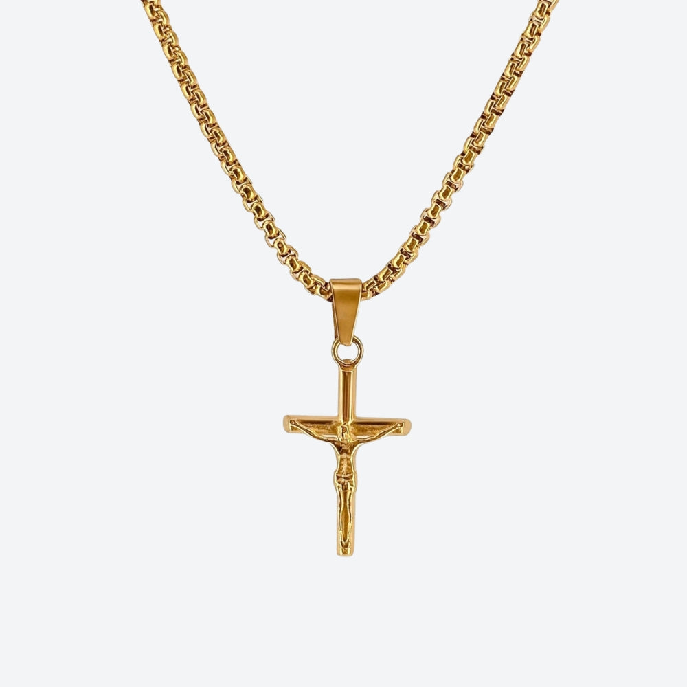 GOLD. A gold crucifix pendant necklace on a matching gold box chain, on a light gray background.