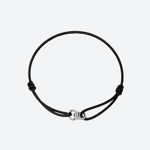A black adjustable cord bracelet with a polished silver-toned infinity link clasp, displayed on a clean light gray background.