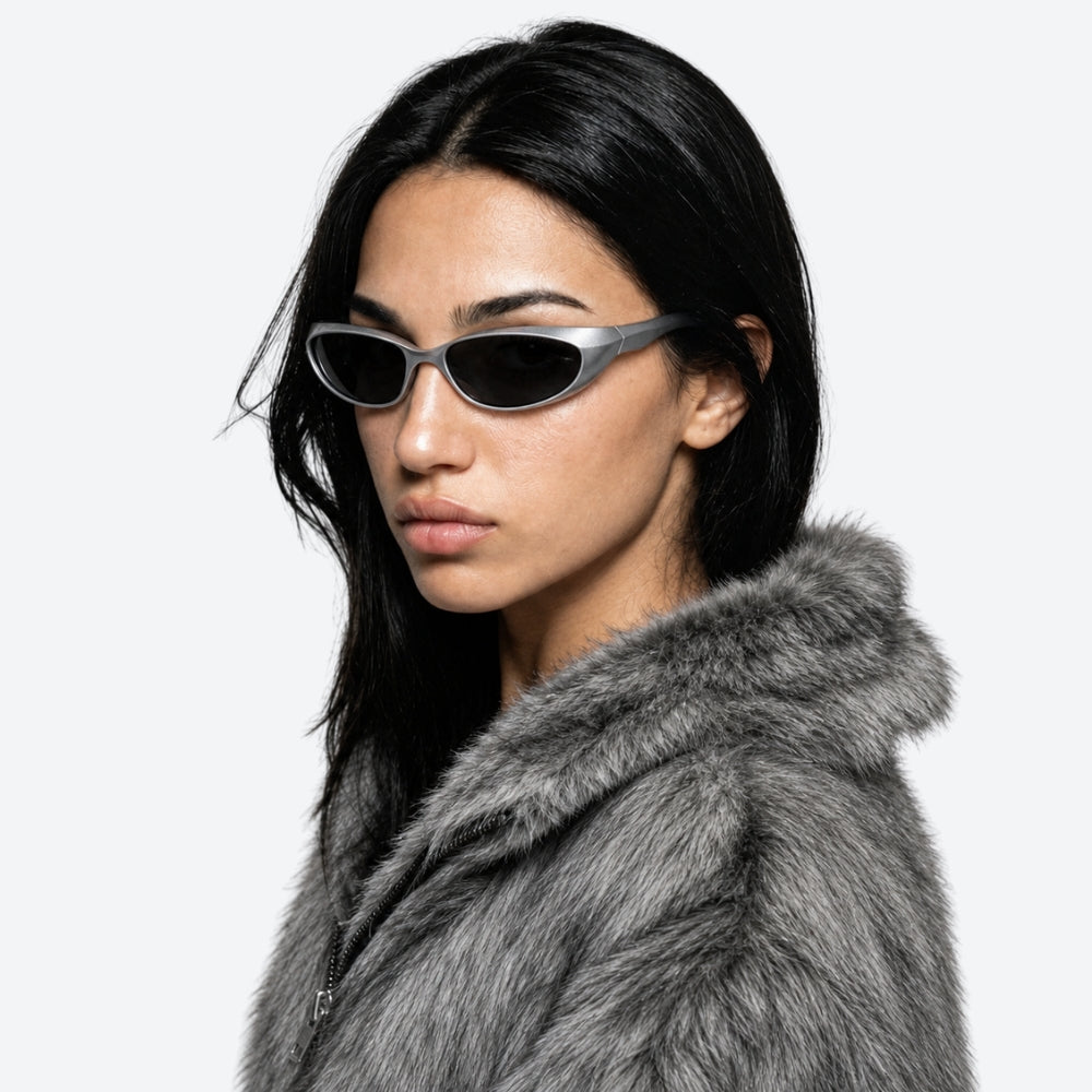 Woman wearing VYSER Silver sunglasses with dark lenses on a white background