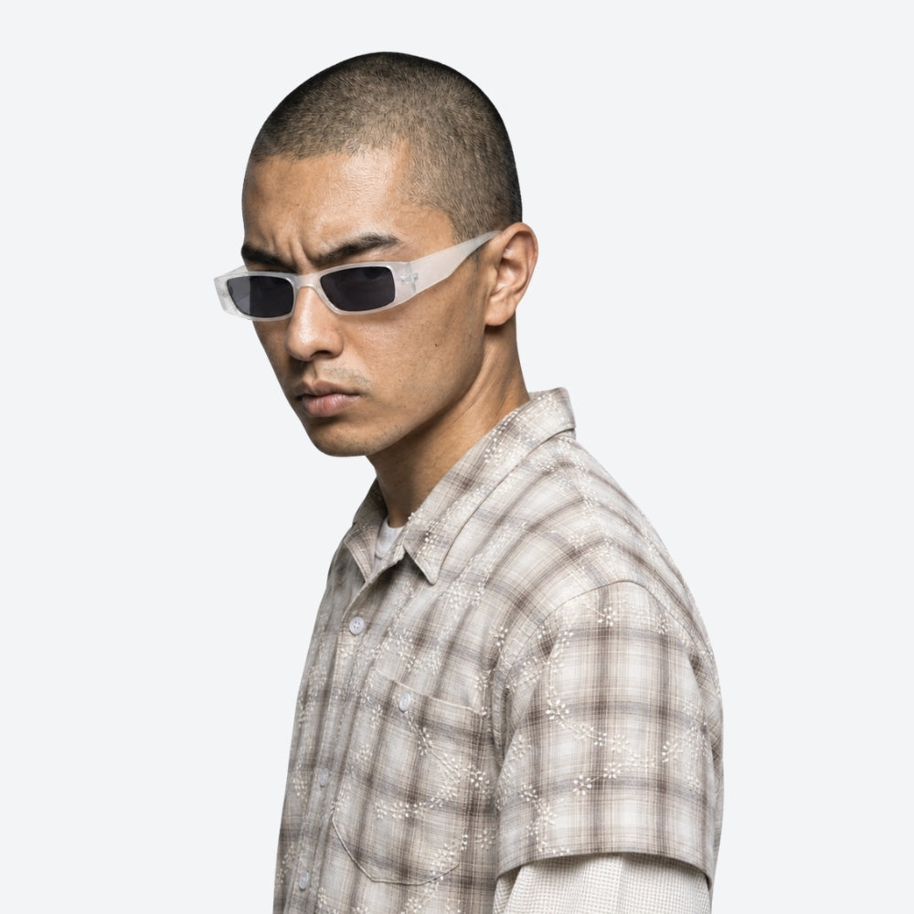 Man wearing VYSER White sunglasses with dark lenses on a white background