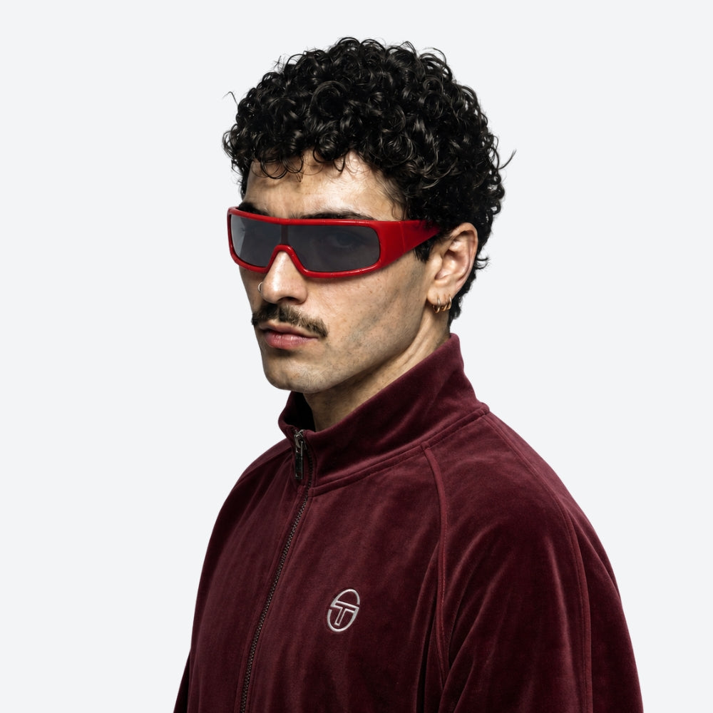 Man wearing red sunglasses and a maroon jacket with VYSER Red sunglasses with gray lenses on a white background