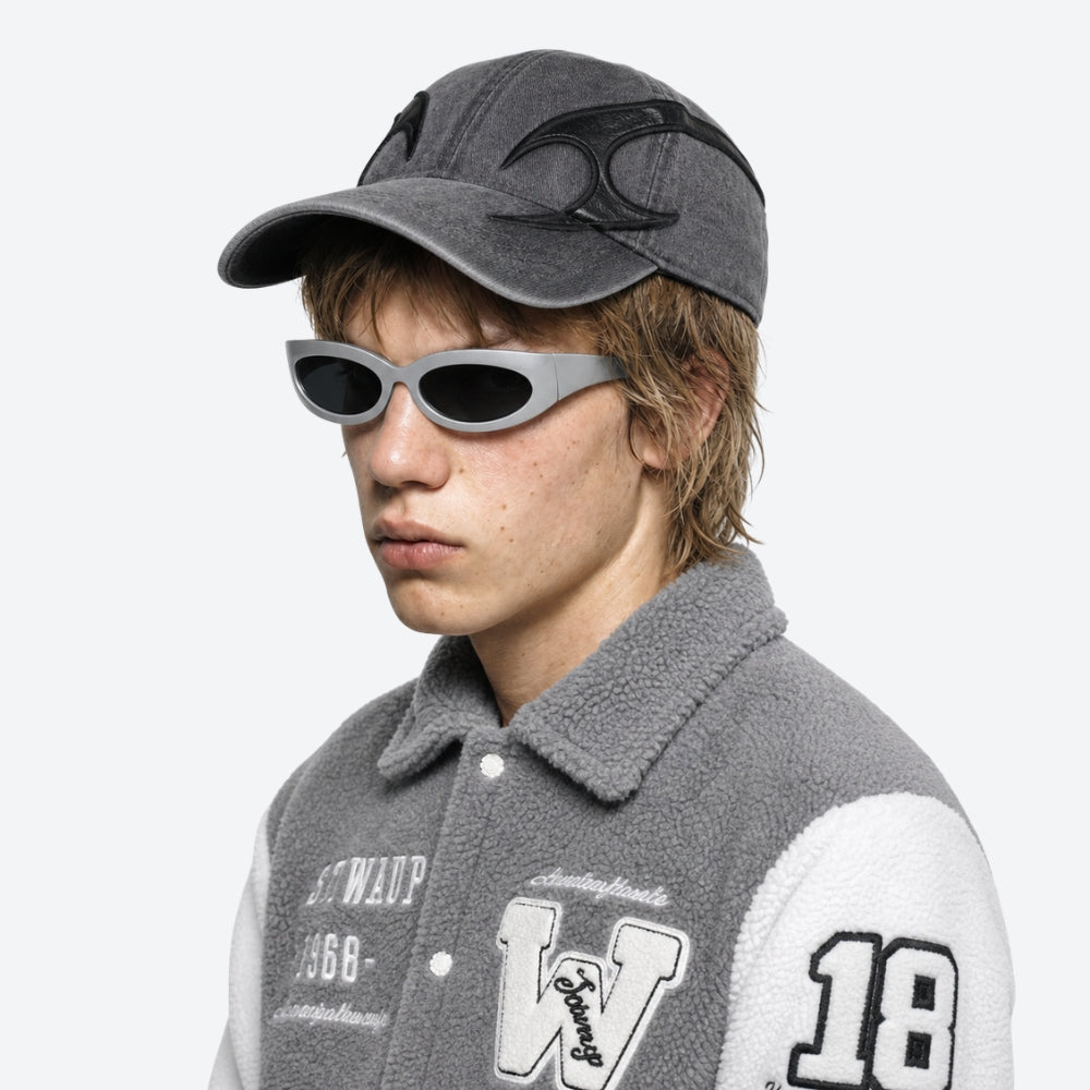 Person wearing a gray cap and VYSER Silver sunglasses with dark lenses on a white background