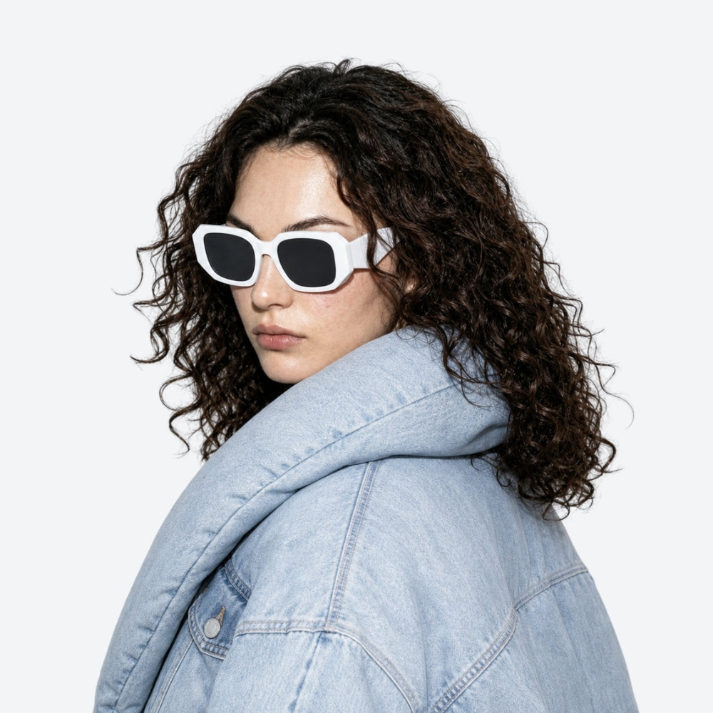 Person wearing VYSER Sunglasses with white frame and black lenses on a white background