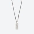 A silver-toned chain necklace with a rectangular pendant shaped like a U.S.