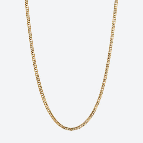 GOLD. A gold-tone Cuban chain necklace with a classic curb link design, shown against a plain light gray background.