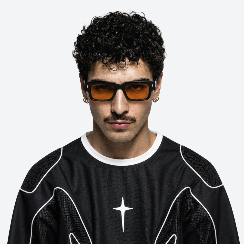 Man wearing VYSER Black sunglasses with orange lenses on a white background